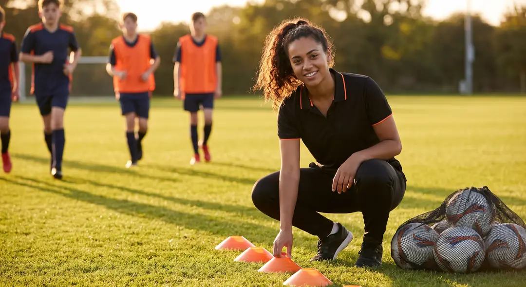Assistant coach setting up a youth soccer practice drill